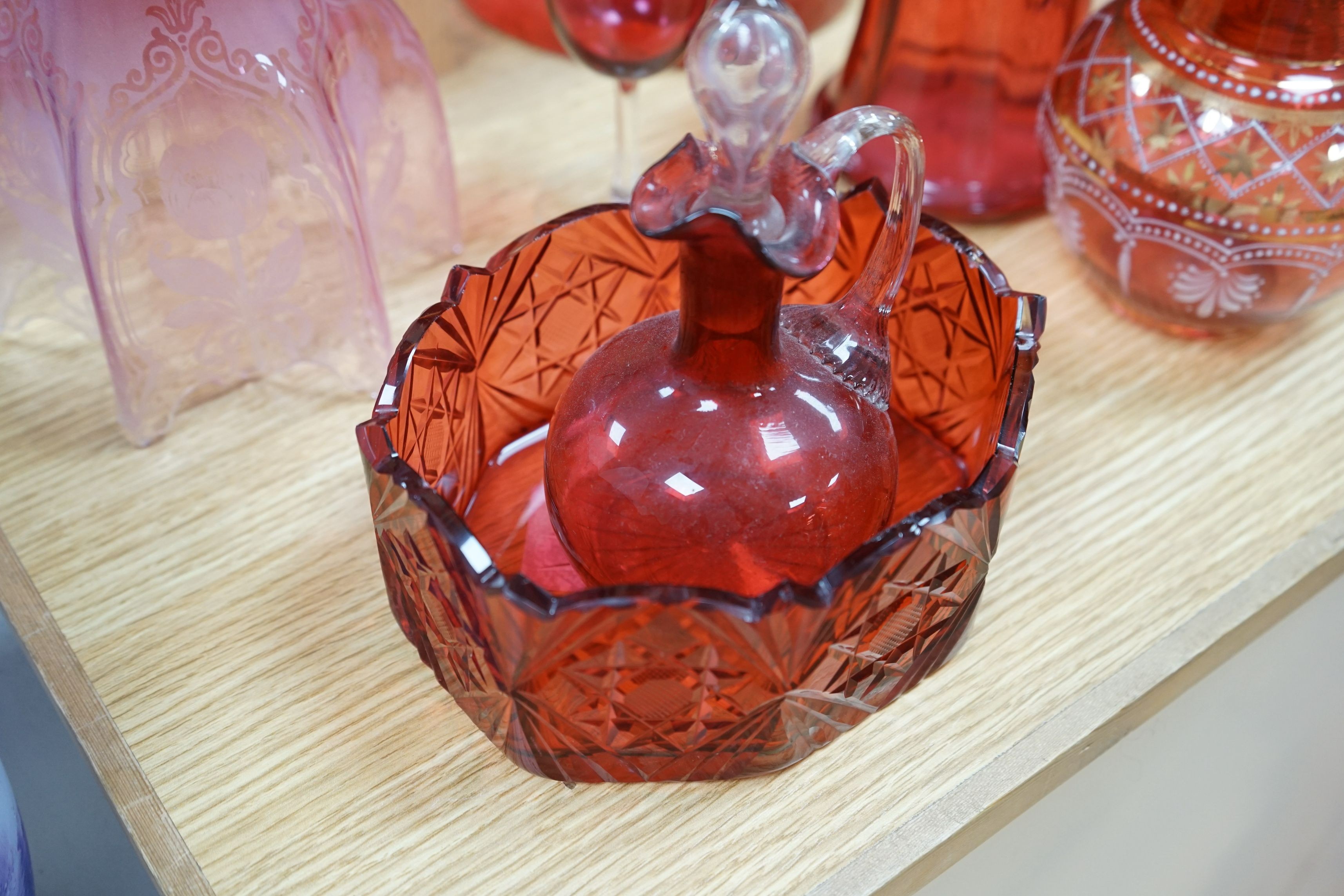 Three cranberry glass shades together with mixed cranberry and other glass, tallest shade 23cms high